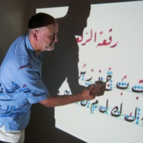 writing Arabic on chalkboard