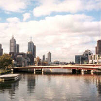city scape with bridge over still water