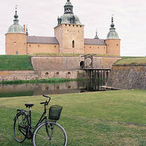 bike parked on grass outside old building