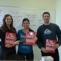 Ecole Quebec Monde students showing off their textbooks.
