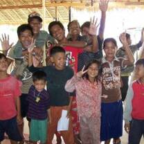 Volunteers and kids waving