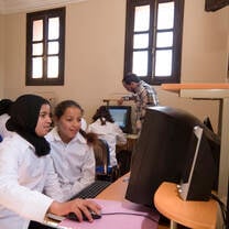 Volunteers helping in a computer room