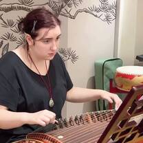 Student learning to play the Chinese guzheng during class at RPL School