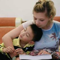 au pair reading with host kid