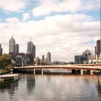 city scape with bridge over still water