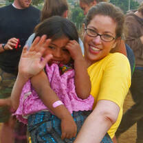 A volunteer enjoys time with a child in our feeding program.