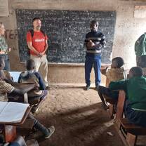 Sharing with class and the local staff interpretes 