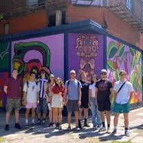 Gap internship group posing in front of street art in Buenos Aires