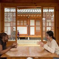 Gap year students in Seoul chatting at table