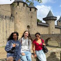 Gap year students smiling in front of castle in France