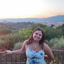 High school student smiling with Italian countryside behind her
