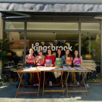 Students at Kingsbrook holding Aula Plus books