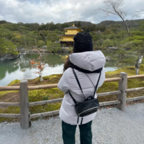 EF Gap Year student visiting Kinkaku-ji, the Golden Pavilion in Kyoto, Japan, taking in the tranquil scenery and reflecting by the temple’s peaceful pond.