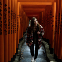 EF Gap Year student exploring a pathway of red torii gates at a shrine in Tokyo, Japan, immersing in local culture and history.
