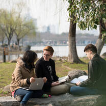Students outside studying. 
