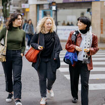Three students cross the street.