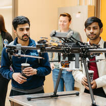 Group of students in classroom, hands on learning. 