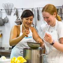 Two girls cooking potatoes for Spanish tortilla