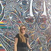 Student in front of the Berlin wall