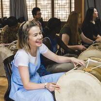 Girl learning traditional Korean drumming