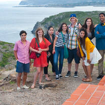 Group of students pose for photo on coast of Spain