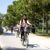 Girl riding bike in Turio Gardens in Valencia