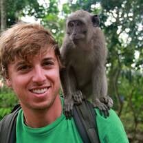 Student interacting with Uluwatu mischievous monkeys
