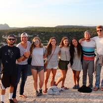 Students watching the sunset on a clifftop in Bonifacio