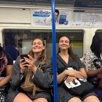 Two girls sitting and smiling on the London Tube