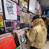 A girl in a record store looking at records