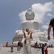 A teacher stands by the giant white Buddha in Phuket 