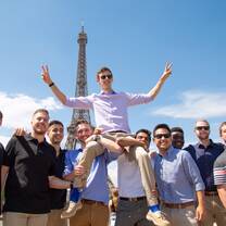 Students posing together at the Eiffel Tower in Paris, an iconic landmark originally built for the 1889 World’s Fair and now one of the most visited monuments in the world.