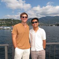 Students enjoying scenic views with the Italian Alps and beach in the background during their study abroad program