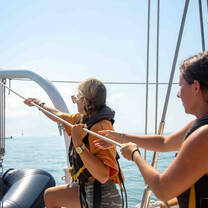 Students hoisting the dinghy onto deck