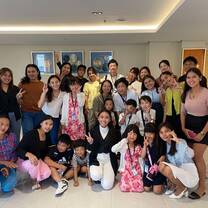 Graduating students posing with their teachers during the ceremony.