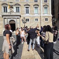 CET Barcelona listening to a guide while outside of a building in Spain