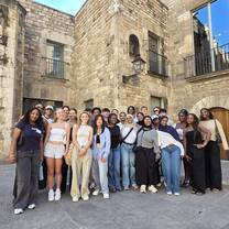 A group of CET Barcelona students standing outside of a building in Spain