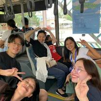 Students and a teacher riding a bus for their Friday practical lesson.