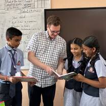International Teacher looking at students work 
