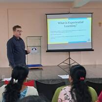 Teacher Trainer presenting to teachers 