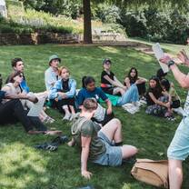 Students in park receiving a lecture