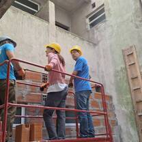 Volunteers working on the construction site of the cultural center.