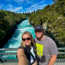Two people standing in front of a river