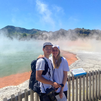 Two people standing in front of natural hot pools