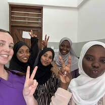 Intern Posing with Zanzibar Locals