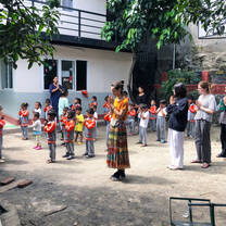 Interns in Nepal Praying with a Class of Children