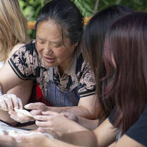 Student make dumplings with local