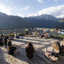 Students meet in circle outside with mountain view