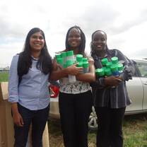 Volunteer with community members new water bottles