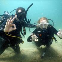 Volunteers scuba diving together during a marine conservation program in southern Tanzania